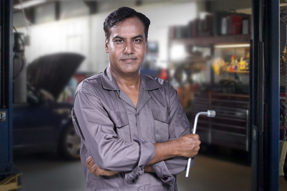Smiling auto mechanic ready for auto glass repair